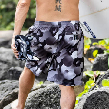 Man with Vast Volley Shorts on rocks